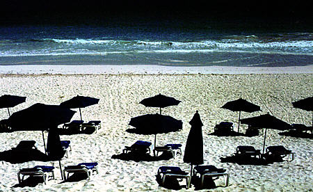 Umbrellas at beach on Harbor Island part of Eleuthera Island. The Bahamas.