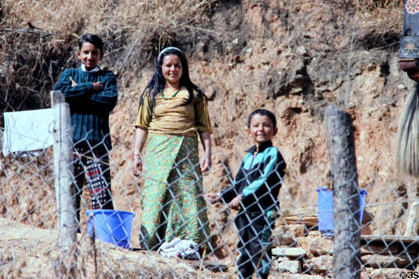 A Paro family beside fence. Bhutan.