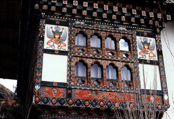 Symbolic murals frame a window on house in Paro. Bhutan.