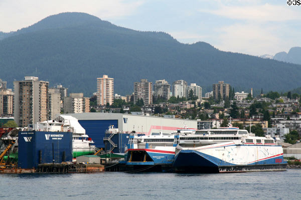 Catamaran ferries Pacificat Discovery & Explorer at shipyard against North Vancouver. Vancouver, BC.