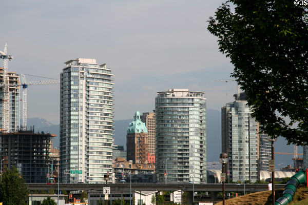 Sun Tower framed between condos seen from False Creek. Vancouver, BC.