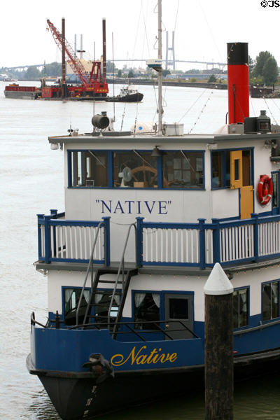 Bow of M.V. Native paddlewheeler against Fraser River traffic. New Westminster, BC.