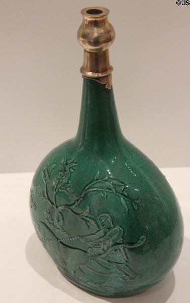 Fritware bottle with raised design of hunter capturing lion with rope (early 17thC) from Iran at Aga Khan Museum. Toronto, ON.
