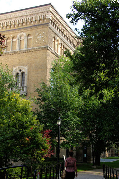 Older structure of Royal Ontario Museum over tree-lined walking path. Toronto, ON.