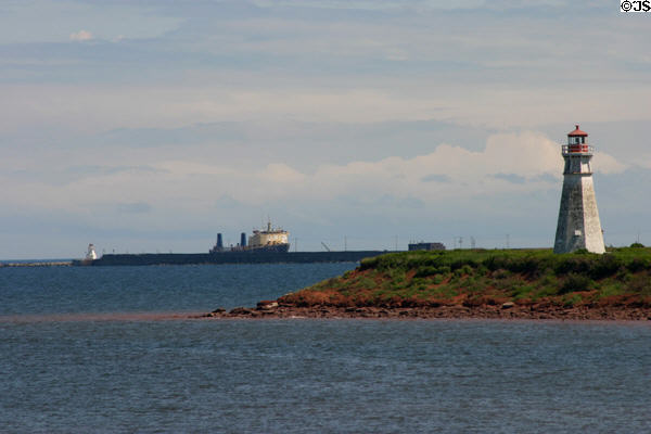Lighthouse & ship at end of Confederation Bridge to PEI. PE.