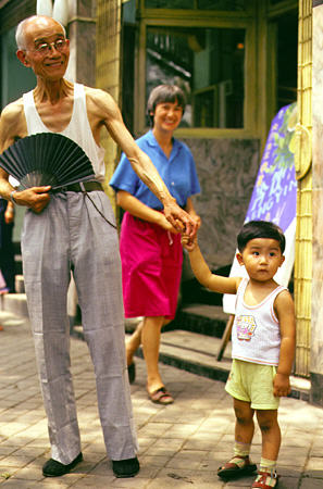 Old man and young boy on the streets of Chengdu. China.