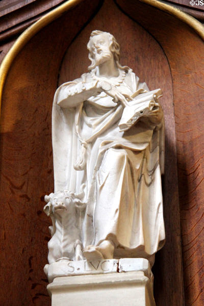 Statue of Evangelist, St Luke, with his attribute bull, on pulpit in St Peter's Church. Hamburg, Germany.