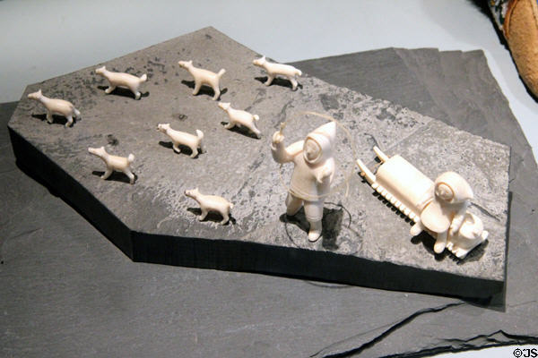 Walrus ivory carving of couple with dog sled (c1960) from Holman Island, Canada at Five Continents Museum. Munich, Germany.