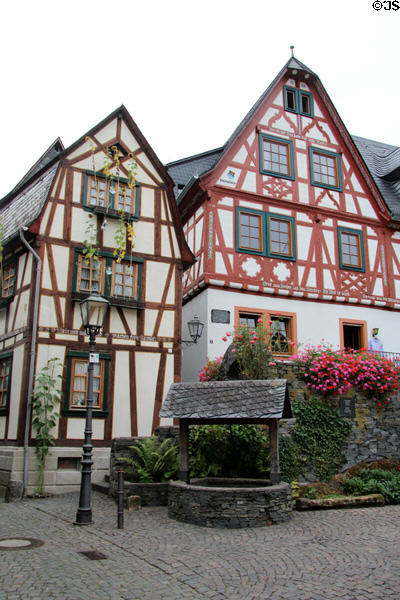 Multi-story half-timbered buildings & old covered well. Bacharach, Germany.