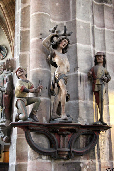 Carved holy figures on column in St Lawrence Church. Nuremberg, Germany.