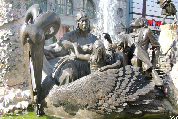 Couple nurturing children on back of symbolic pelican detail on Marriage Carousel sculpture. Nuremberg, Germany.