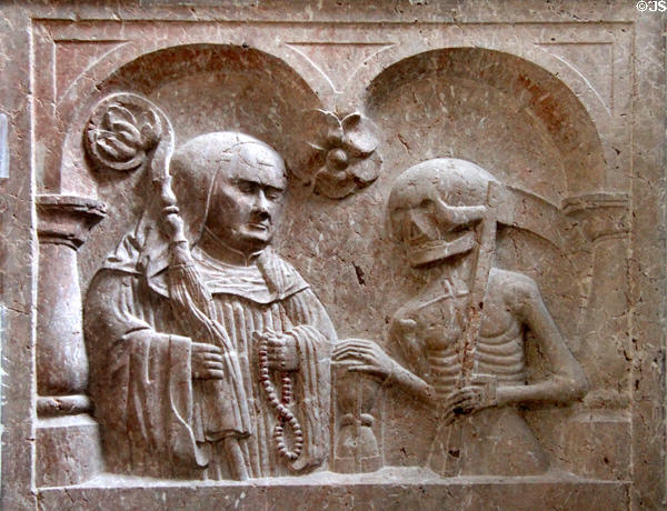 Stone carving (1554) on coffin lid on which Abbot Gregor von Füssen is depicted together with Grim Reaper with an hour glass between them in St Anna's Chapel at Museum of City of Füssen in Kloster Mang. Füssen, Germany.
