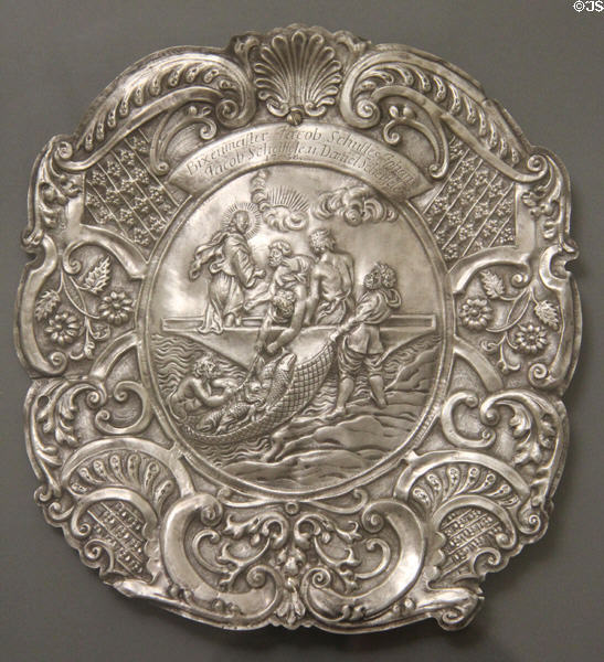 Silver plate embossed with scene of Christ directing disciples where to cast net (1738) engraved with names of local fishermen at Ulmer Museum. Ulm, Germany.