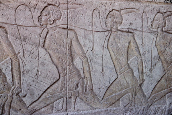 Carved row of subjugated Nubian slaves on face of Great Temple of Ramesses II at Abu Simbel. Egypt.