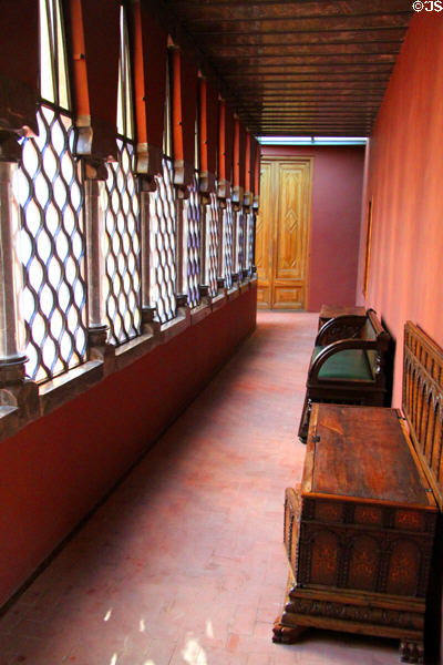 Passageway with antique benches at Palau Güell. Barcelona, Spain.