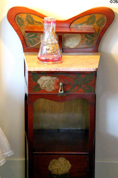 Art Nouveau (Modernista) bedside table in museum apartment at Casa Milà. Barcelona, Spain.