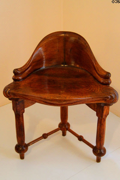Modernista corner chair (c1900) designed for Casa Calvet in Barcelona by Antoni Gaudí at Gaudi House Museum in Parc Güell. Barcelona, Spain.