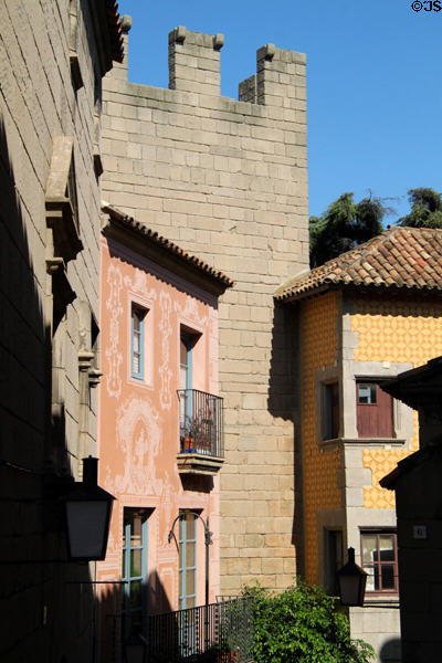 Crenellated Portal d'en Bover over stuccoed houses of Catalonia at Poble Espanyol (1929 replica). Barcelona, Spain.