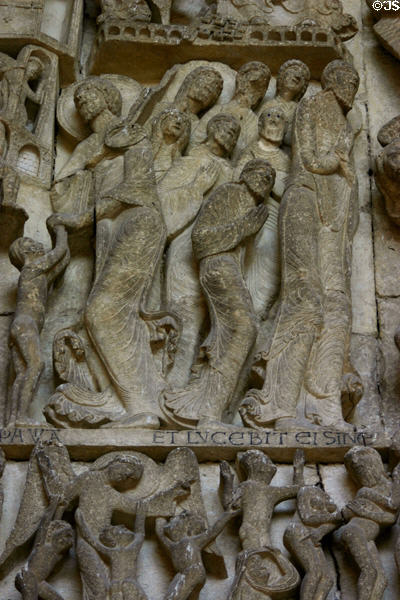 Detail of apostles attending the weighing of soles at Last Judgment on tympanum of Cathedral St Lazarre. Autun, France.