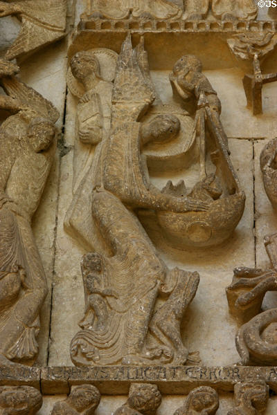 Detail of angel placing sole in balance pan at Last Judgment on tympanum of Cathedral St Lazarre. Autun, France.