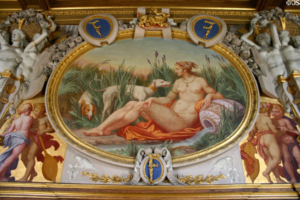 Oval painting of naked nymph with two dogs in François I gallery in Fontainbleau Palace. Fontainbleau, France.