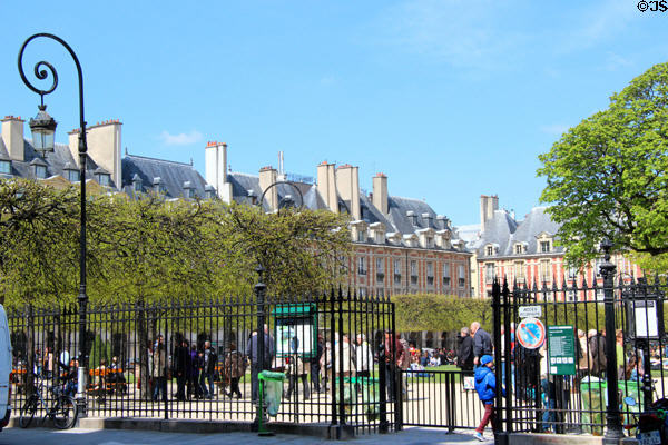 Street lamp & iron fence at Place des Vosges. Paris, France.
