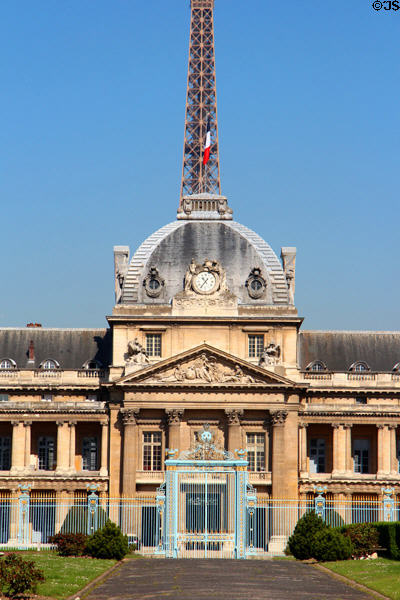 Central clock tower of Ecole Militaire with Eiffel Tower beyond. Paris, France.