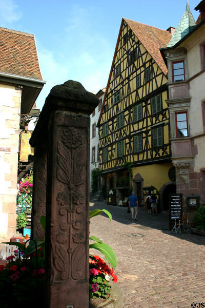 Carved stone marker & "Le gratte-ciel" half-timbered house. Riquewihr, France.