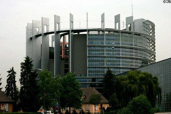 Round tower of Palais de l'Europe with menhir-like vertical slabs & openings. Strasbourg, France.