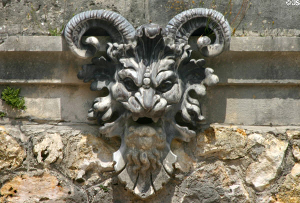 Horned grotesque face in grottos of Vaux-le-Vicomte chateau. Melun, France.