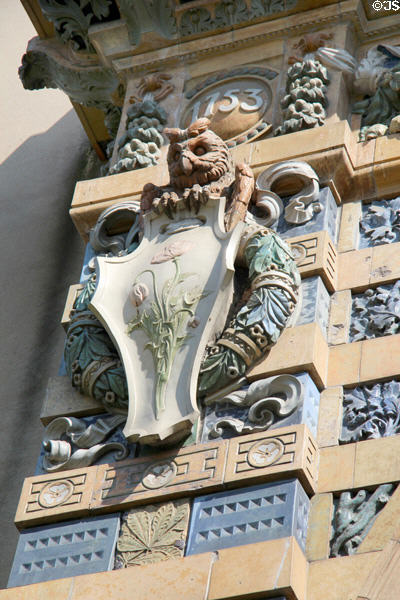 Detail of upper left corner with scroll relief of poppies on Sevres Arch at St-Germain-des-Prés. Paris, France.