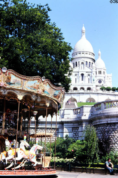 Carrousel beneath Montmartre Basilica of the Sacred Heart of Paris church. Paris, France.