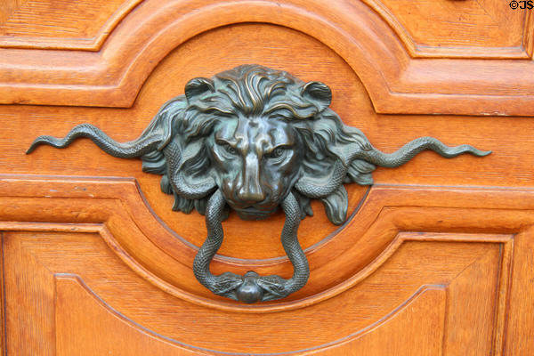 Lion door knocker on Paris gront door. Paris, France.