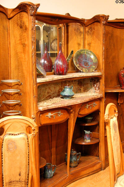 Guimard dining room sideboard (c1909) by Hector Guimard displaying ceramics by Pierre-Adrien Dalpayrat at Petit Palace Museum. Paris, France.