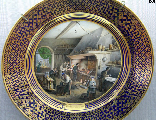 Sèvres porcelain plates showing industrial art of metalwork (1820-35) by Jean-Charles Develly at Sèvres National Ceramic Museum. Paris, France.