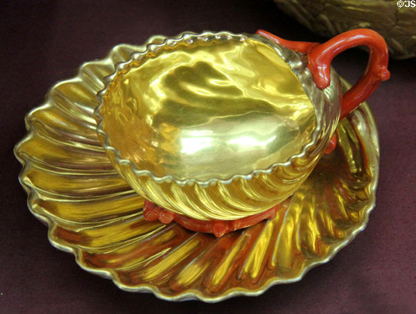 Porcelain red & gold shell-shaped cup & saucer (c1810) by Manufacture Dagoty of Paris at Sèvres National Ceramic Museum. Paris, France.