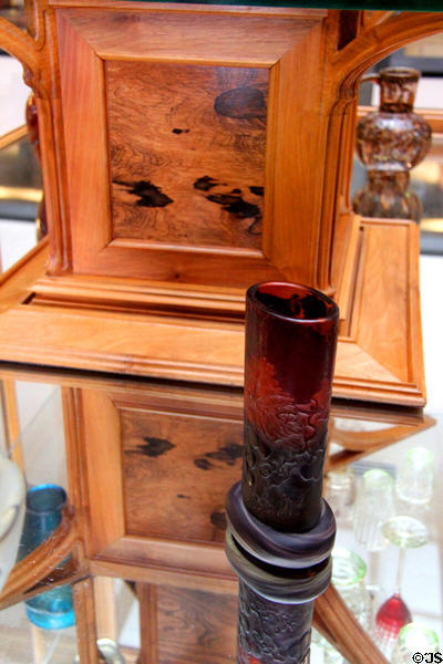 Art Nouveau support pillar in Émile Gallé display case (1904) beyond Gallé vase at Arts et Metiers Museum. Paris, France.