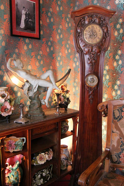 Art Nouveau tall clock beside ceramics collection at Maxim's Art Nouveau Collection 1900. Paris, France.