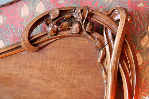 Detail of carved bedstead headboard at Maxim's Art Nouveau Collection 1900. Paris, France.