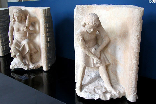 Statues of Eve carrying a spindle & her son, Cain, working the earth at Tau Palace Museum. Reims, France.