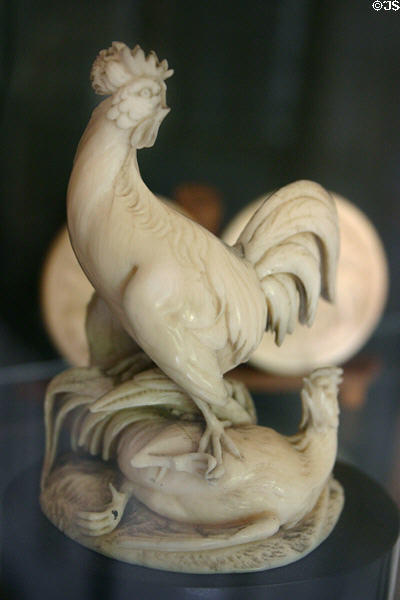 Bone carving of roosters fighting at Dieppe Castle Museum. Dieppe, France.