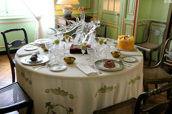 Dining table with glass deer head in family dining room at Cheverny Chateau. Cheverny, France.