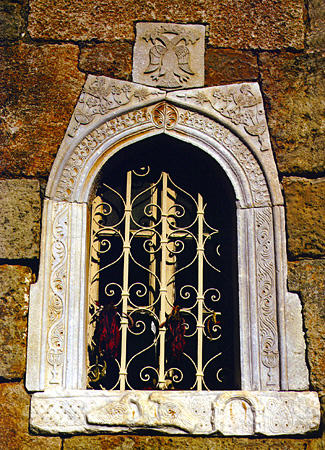 Window detail from Agios Spyridon with Byzantine eagle in Kardamili, Messiniakos Bay. Greece.