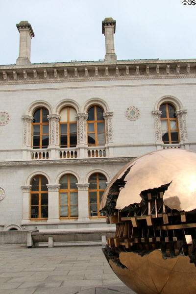 Sphere Within Sphere sculpture (1982) by Arnaldo Pomodoro & Museum Building at Trinity College. Dublin, Ireland.