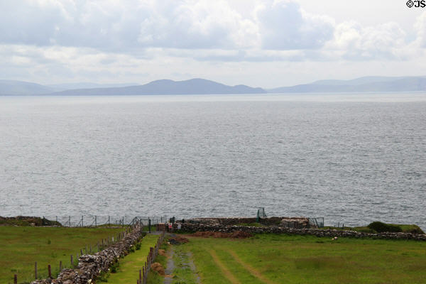 Dingle Bay view with ruins of Dunbeg iron age fort on loop road around Dingle Peninsula. Ireland.