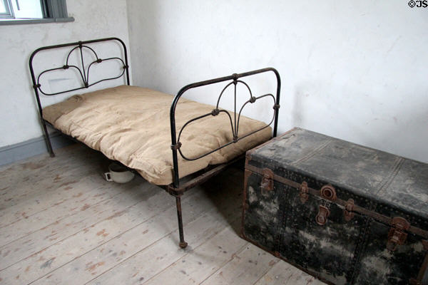 Iron frame bed & clothing trunk in Matron's quarters at Irish Workhouse Centre. Portumna, Ireland.