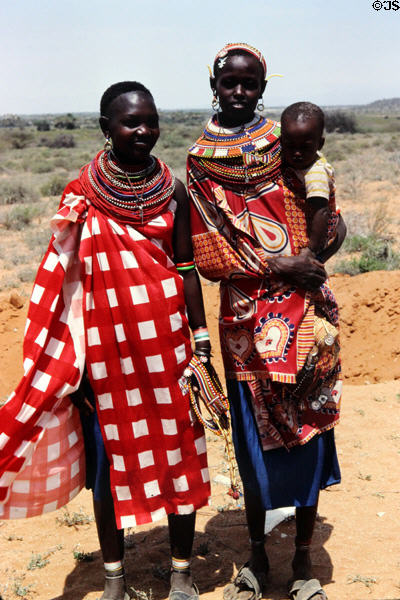 Samburu women in traditional colorful sarong dress & layers of necklaces. Kenya.
