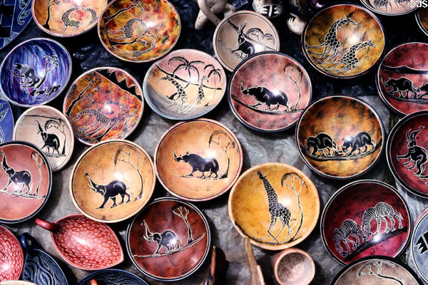 Painted clay dishes with animal themes at a crafts market near Nairobi. Kenya.