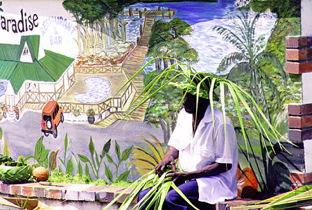 Weaving hats and baskets of palm leaves at Marigot Bay. St Lucia.