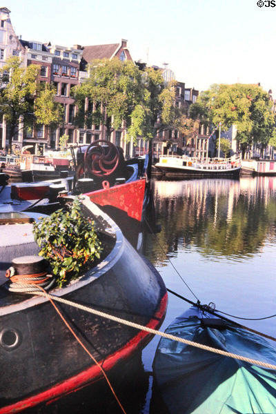 Barges & houseboats on the Amstel near opera. Amsterdam, Netherlands.